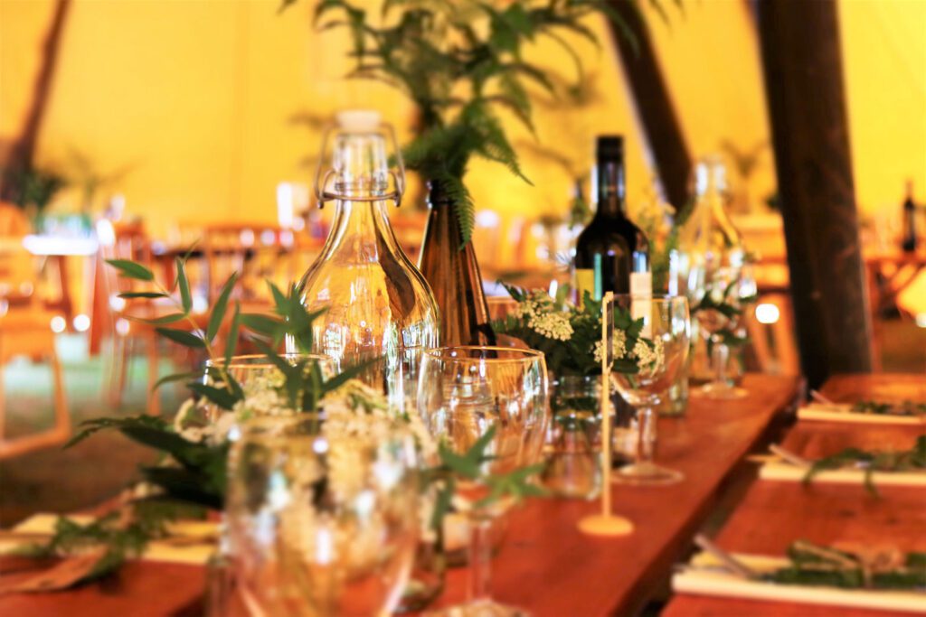 A table with wine glasses and bottles on it